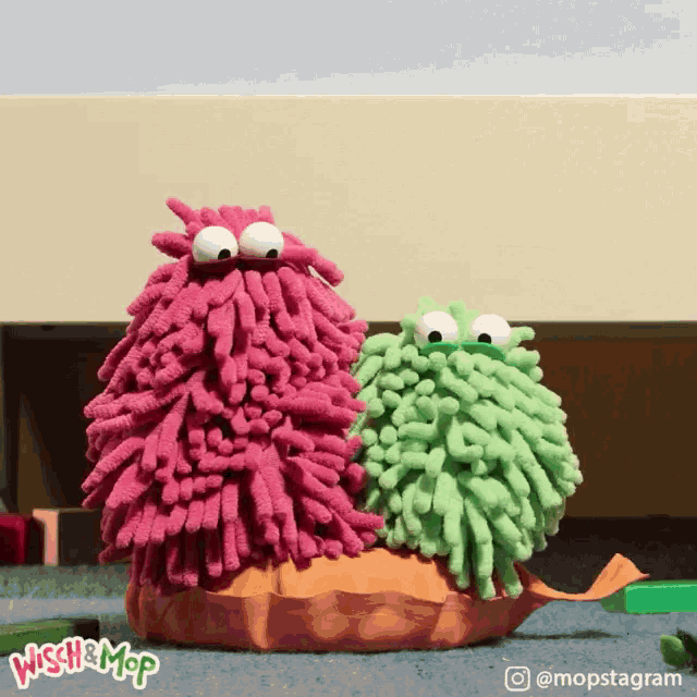 two stuffed animals are sitting next to each other with the words wish & mop on the bottom right