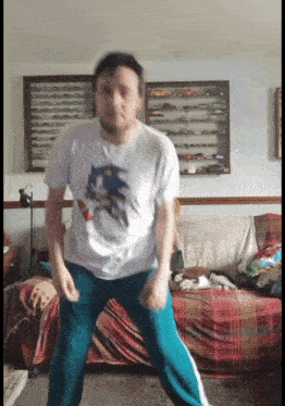 a man wearing a sonic the hedgehog shirt is dancing