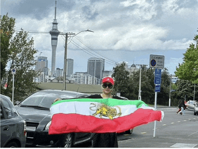 a person holding a flag in front of a sign that says clearway