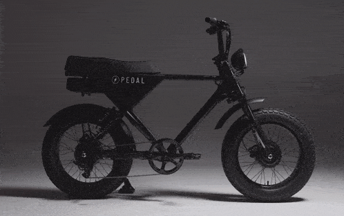 a black pedal bicycle with a large tire