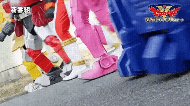 a group of robots are walking down a street with the date 3/7/2014 on the bottom right