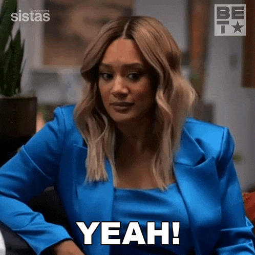 a woman in a blue suit says " yeah "