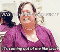 a woman in a purple dress is sitting in front of a mirror and screaming .