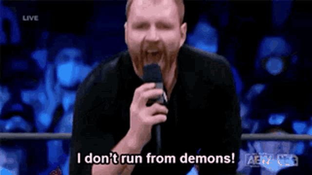 a man with a beard is talking into a microphone and saying i just beat the shit outta them