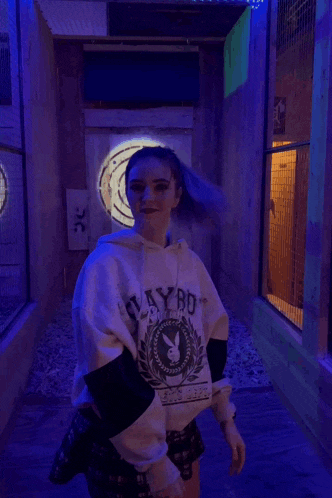 a girl with purple hair wearing a playboy sweatshirt