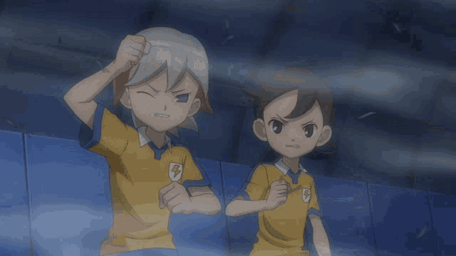 a boy with a lightning bolt on his shirt is standing next to another boy