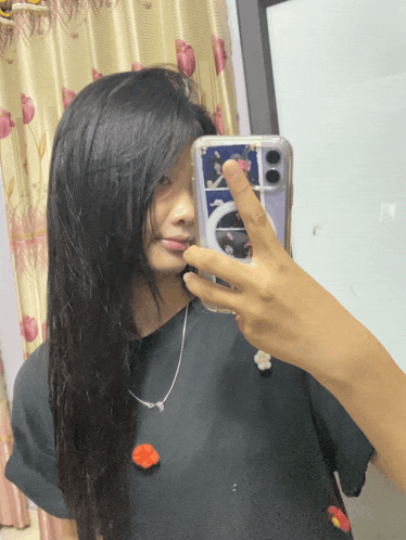 a woman taking a picture of herself in the mirror with her phone