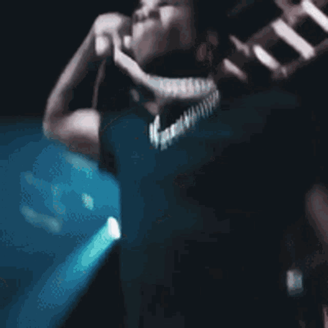 a blurry picture of a person playing a violin
