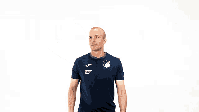 a man wearing a blue shirt with the letters ec on the front