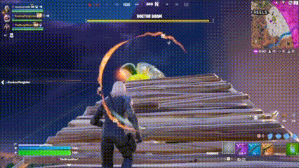 a person is playing a video game while holding a sword in their hand .