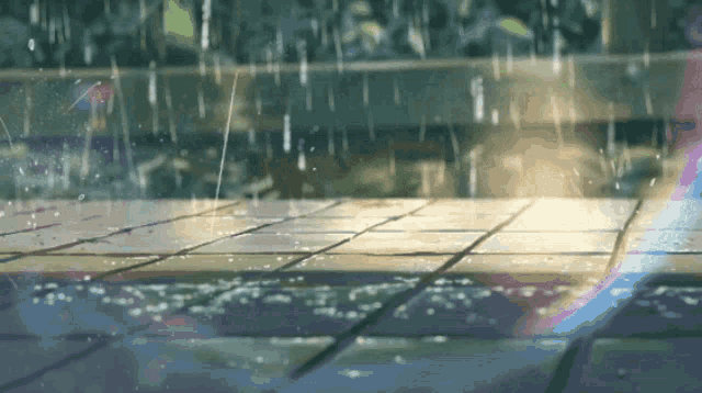 rain is falling on a tiled floor with the sun shining through it