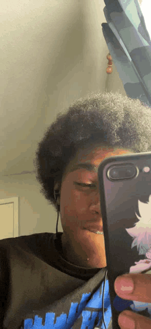 a person taking a picture of themselves with a cell phone