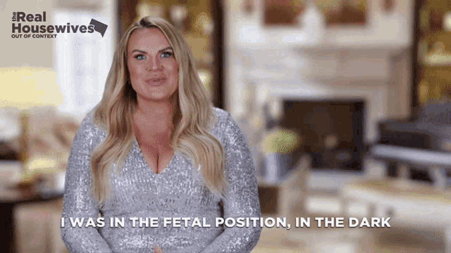 a woman in a silver sequined dress says " i was in the fetal position "