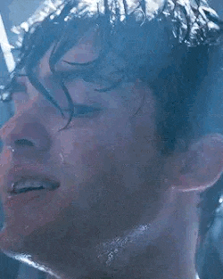 a close up of a man 's face with water coming out of his nose and mouth .