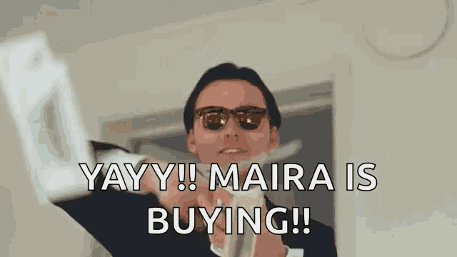a man wearing sunglasses is holding a bunch of money in his hand and saying `` yay ! maira is buying ! ''