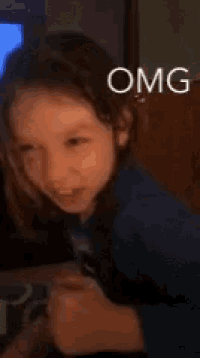 a little girl is making a funny face and the words omg are on the bottom of the picture .
