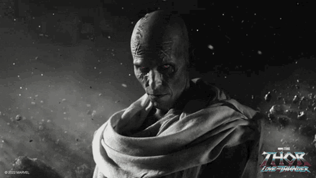 a black and white photo of a man with a scarf around his neck and the word thor on the bottom