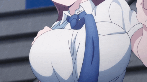a close up of a woman 's breasts with a blue tie around her neck