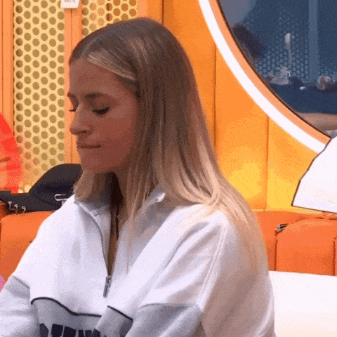 a woman wearing a white sweater with the word puma on the front