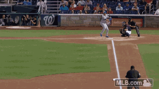 a baseball player with the number 28 on his jersey catching a ball