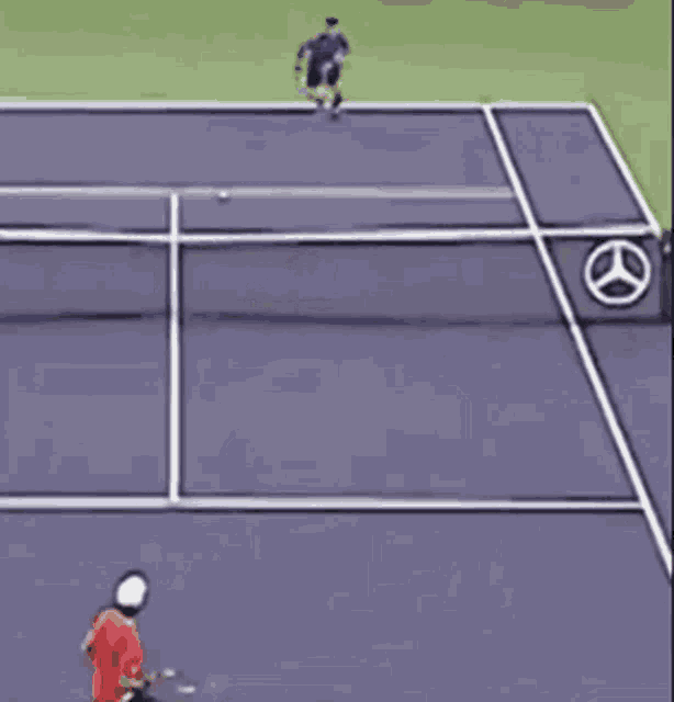 a man in a red shirt is playing tennis on a mercedes tennis court