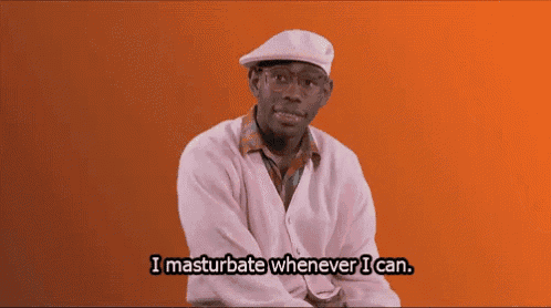 a man wearing a hat and a pink shirt says i masturbate whenever i can