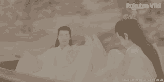 a couple in a boat with rakuten viki written on the bottom