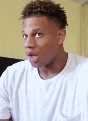 a man in a white shirt sticks his tongue out