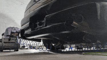 a car is being worked on in a garage with a compressor that says ' lg ' on it