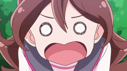 a close up of a girl 's face with a surprised look on her face