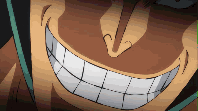 a close up of a man 's face with a huge smile
