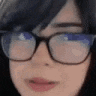 a close up of a woman wearing glasses and looking at the camera .