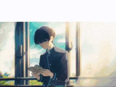 a boy in a school uniform is reading a book while standing in front of a window