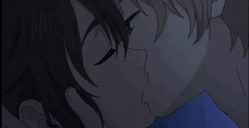 a man and woman kissing in a dark room