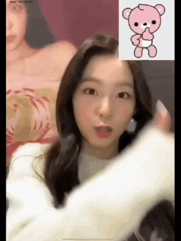 a woman is talking on a video call with a pink teddy bear on the screen .