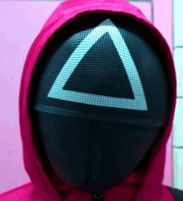 a person wearing a mask with a triangle on it and a hood .