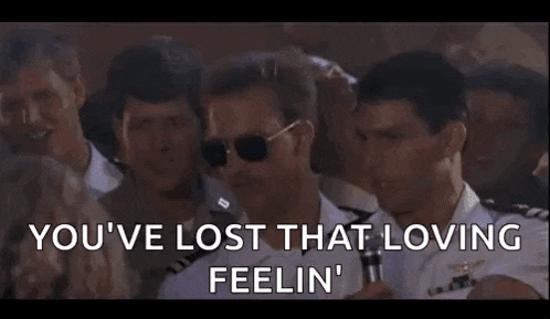 a man wearing sunglasses is standing in a crowd of people and says `` you 've lost that loving feeling '' .