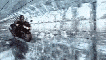 a man is riding a motorcycle in a tunnel .