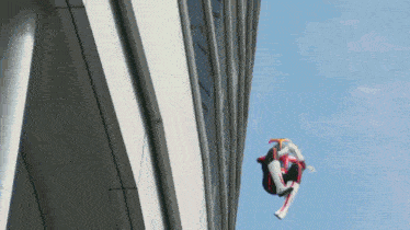 a person in a superhero costume is flying through the air
