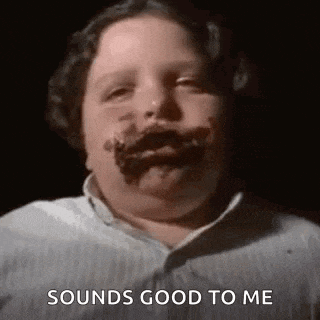 a young boy with chocolate on his face is making a funny face and saying `` sounds good to me '' .