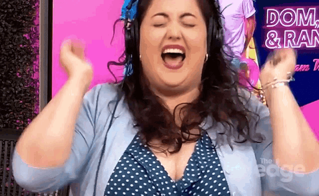 a woman wearing headphones is singing in front of a sign that says dom and rain