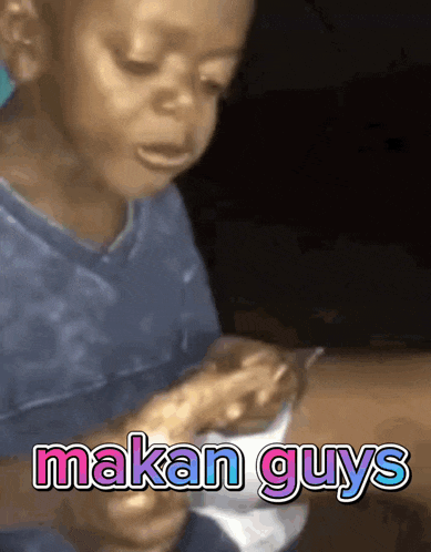 a young boy is crying while eating food with the words makan guys written above him