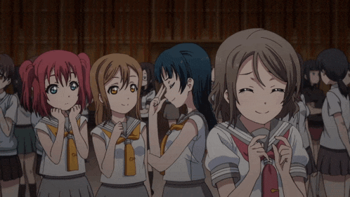 a group of anime girls are standing in a line and one of them is smiling