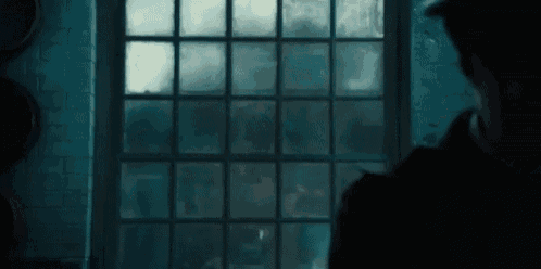 a man in a hat is looking out of a window at a ghost .