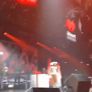 a blurred image of a stage with a sign that says iheartradio on it