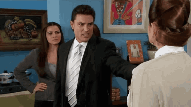 a man in a suit and tie is talking to a woman