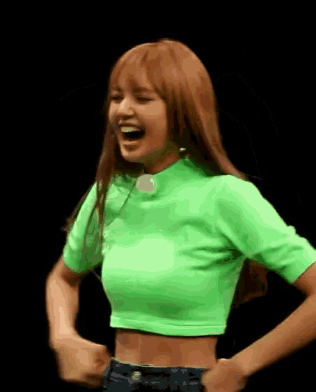 a woman in a neon green crop top and jeans is laughing and flexing her muscles .