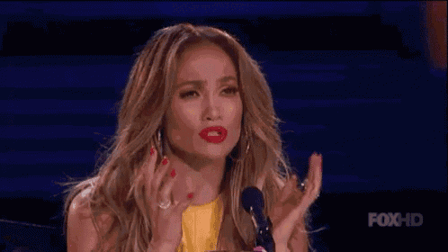 a woman is giving a speech on a stage and says `` deal with it '' .
