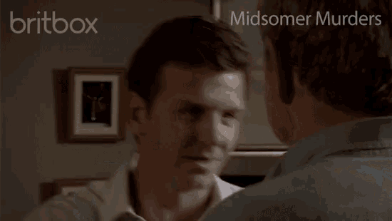 two men hugging with the words midsomer murders on the bottom right