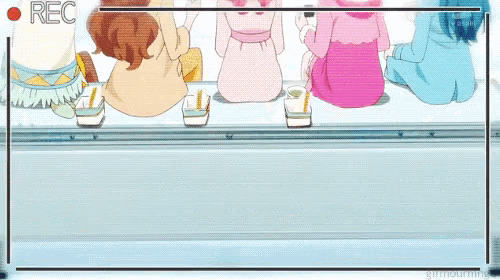 a group of girls are sitting on a ledge with a rec button in the corner